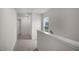 Upstairs hallway with carpet and a view from the large window at 180 Starlight St, Sanford, NC 27330