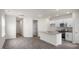 Open-concept living space featuring modern kitchen, wood-look floors, and ample natural light, great for entertaining at 180 Starlight St, Sanford, NC 27330