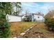 Expansive backyard with a shed, wooden deck, lush greenery, and verdant grass at 1817 Rankin St, Raleigh, NC 27604