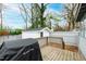 A backyard featuring an outdoor shed, deck, and black grill beneath a canopy of trees against a blue sky at 1817 Rankin St, Raleigh, NC 27604