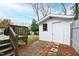 Backyard showcases a well-maintained shed on a stone foundation with steps leading to a wooden deck at 1817 Rankin St, Raleigh, NC 27604
