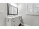 Bathroom with a white vanity with marble countertop, silver faucet and decorative mirror at 1817 Rankin St, Raleigh, NC 27604