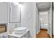 Bathroom features a modern white sink and vanity with silver hardware, next to a doorway at 1817 Rankin St, Raleigh, NC 27604