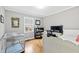 Neutral bedroom featuring hardwood floors, a window, and office area with desk, chair and dual monitors at 1817 Rankin St, Raleigh, NC 27604
