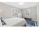 Bedroom features white bedding and two windows with white shutters and hardwood floors at 1817 Rankin St, Raleigh, NC 27604
