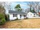 Charming single-story home with white siding, black shutters, and a well-manicured front yard at 1817 Rankin St, Raleigh, NC 27604