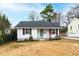 Charming one-story home with white siding, black shutters, and a neatly maintained front yard at 1817 Rankin St, Raleigh, NC 27604