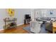 Open-concept living space showcasing hardwood floors, a gray sofa, and a stylish bar cart at 1817 Rankin St, Raleigh, NC 27604
