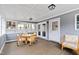 Cozy sunroom featuring wood floors, wainscoting, ample light from windows, and wicker furniture and decor at 1817 Rankin St, Raleigh, NC 27604