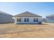 View of the spacious backyard, highlighting the home's siding and ample yard space at 185 White Birch Ln, Angier, NC 27501