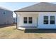 Rear of the home showing covered patio and the large backyard perfect for entertaining and outdoor living at 185 White Birch Ln, Angier, NC 27501