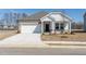 Charming single-story home featuring a brick facade, white siding, and an attached two-car garage at 185 White Birch Ln, Angier, NC 27501