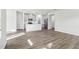 Bright kitchen featuring white cabinetry, stainless steel appliances, a center island, and wood-look flooring at 185 White Birch Ln, Angier, NC 27501