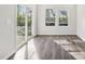 This living room features luxury vinyl plank flooring, large windows and a glass patio door at 185 White Birch Ln, Angier, NC 27501