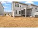 View of the backyard with a screened porch, fenced yard, and ample space for outdoor activities at 193 Millennium Dr, Pittsboro, NC 27312