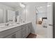 Bathroom featuring double sinks, gray cabinets and connecting to the bedroom at 193 Millennium Dr, Pittsboro, NC 27312