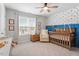 Adorable Bedroom with a crib, accent wall, and playful decor at 193 Millennium Dr, Pittsboro, NC 27312