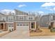 Beautiful gray townhome with a two-car garage, stylish front door, and well-maintained yard at 193 Millennium Dr, Pittsboro, NC 27312