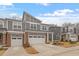 Charming new townhome exterior with brick accents, garages, and manicured landscaping at 193 Millennium Dr, Pittsboro, NC 27312