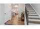 Inviting foyer with hardwood floors, staircase, and a view into the open-concept living area at 193 Millennium Dr, Pittsboro, NC 27312