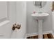 Clean half bath featuring a pedestal sink and a wood look floor at 193 Millennium Dr, Pittsboro, NC 27312