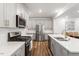 Bright and spacious kitchen featuring gray cabinets, stainless steel appliances, and quartz countertops at 193 Millennium Dr, Pittsboro, NC 27312