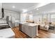 Open-concept living area with kitchen island, dining space, and comfortable seating at 193 Millennium Dr, Pittsboro, NC 27312