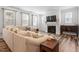 Bright living room featuring a cozy sectional sofa, fireplace, and natural light from large windows at 193 Millennium Dr, Pittsboro, NC 27312