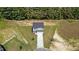 Aerial view of a two-story home with a gray exterior and black roof, situated on a verdant lawn at 20 Diamond Creek Dr, Zebulon, NC 27597