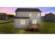 Back exterior view of a two-story home with a wooden deck at sunset at 20 Diamond Creek Dr, Zebulon, NC 27597
