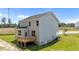 Elevated back view of a two-story home with a wooden deck and spacious lawn at 20 Diamond Creek Dr, Zebulon, NC 27597