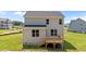 Back exterior view of a two-story home with a wooden deck and spacious lawn at 20 Diamond Creek Dr, Zebulon, NC 27597
