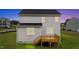 Exterior view of house with wooden deck, set against a twilight sky and grassy yard at 20 Diamond Creek Dr, Zebulon, NC 27597