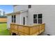 Backyard wooden deck with stairs leading to the home's siding and manicured lawn at 20 Diamond Creek Dr, Zebulon, NC 27597