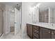 Modern bathroom with double sink vanity, quartz counters, and tiled shower at 20 Diamond Creek Dr, Zebulon, NC 27597