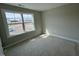 Bright and airy bedroom with a large window offering a view and a neutral color scheme at 20 Diamond Creek Dr, Zebulon, NC 27597
