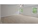 Bright, spacious bedroom with neutral carpet, ceiling fan, and two large windows at 20 Diamond Creek Dr, Zebulon, NC 27597
