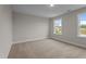 Bright bedroom featuring neutral walls, plush carpeting and natural light from double-hung windows at 20 Diamond Creek Dr, Zebulon, NC 27597