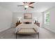 Cozy bedroom with soft neutral colored carpet, large windows, and a comfortable bed at 20 Diamond Creek Dr, Zebulon, NC 27597