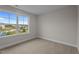 Neutral bedroom with light carpet; large window overlooks a clear, sunny day at 20 Diamond Creek Dr, Zebulon, NC 27597