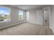 Bedroom featuring two windows and adjacent closet and bathroom doors at 20 Diamond Creek Dr, Zebulon, NC 27597