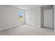 Bright bedroom features neutral carpet, closet doors, and natural light from the window at 20 Diamond Creek Dr, Zebulon, NC 27597