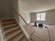 Welcoming entryway featuring a staircase, leading to an open living area and neutral walls at 20 Diamond Creek Dr, Zebulon, NC 27597