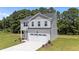 Charming two-story home with a well-manicured lawn and a spacious two car garage at 20 Diamond Creek Dr, Zebulon, NC 27597