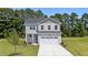 Charming two-story home with a well-manicured lawn and a spacious two car garage at 20 Diamond Creek Dr, Zebulon, NC 27597