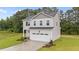 Charming two-story home with landscaped yard and an attached two-car garage at 20 Diamond Creek Dr, Zebulon, NC 27597