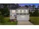 Charming two-story home with landscaped yard and an attached two-car garage at 20 Diamond Creek Dr, Zebulon, NC 27597