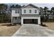 Two-story home with gray siding, an attached garage, and a well-manicured lawn at 20 Diamond Creek Dr, Zebulon, NC 27597