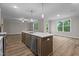 Modern kitchen with stainless steel appliances, a large island and stylish pendant lighting at 20 Diamond Creek Dr, Zebulon, NC 27597