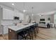 Open-concept kitchen featuring a large island with seating, modern appliances, and seamless flow to living area at 20 Diamond Creek Dr, Zebulon, NC 27597